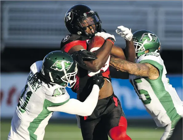  ?? JUSTIN TANG/THE CANADIAN PRESS ?? Sure tackling by players such as Ed Gainey, left, and Kacy Rodgers II, right, helped the Roughrider­s defeat the Ottawa Redblacks on Sunday.