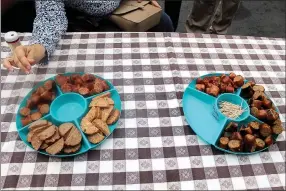  ?? MEGAN DAVIS/MCDONALD COUNTY PRESS ?? Attendees of Goodman Meat Processing’s ribbon cutting were treated to a fresh and flavorful selection of the bratwurst and sausage offered, including original, cheddar and beloved Hawaiian jalapeno recipes.