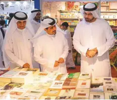  ??  ?? Mohammad Abdullah Al Gergawi (right) and Ahmad Al Ameri (centre) tour the Sharjah book fair on Wednesday. WAM