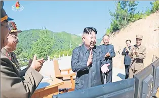  ?? AP PHOTO ?? This image made from video of a news bulletin aired by North Korea’s KRT on Tuesday shows what was said to be North Korea leader Kim Jung Un applauding after the launch of a Hwasong-14 interconti­nental ballistic missile.