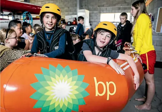  ?? DAVID UNWIN/STUFF ?? Marton School pupils Sophie Duffy, left, and Grindon Welch try out a boat on dry land during an education programme at Himatangi Beach.