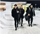  ??  ?? Cold trip: Mesut Ozil leads the Arsenal players onto the team bus in Sweden