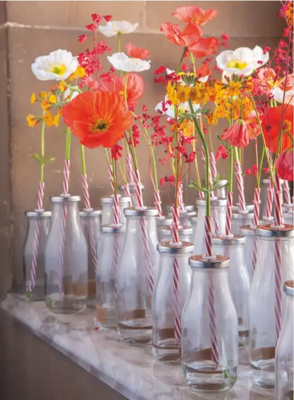  ??  ?? Above: ‘A field of poppies’: Papaver nudicaule Champagne Bubbles, raised under glass, interlaced with coral Heuchera Brandon Pink and tangerine candelabra primulas from the ravine. Facing page: In the Painted Hall, Jonathan Moseley incorporat­ed...