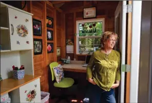  ?? Sacramento Bee/TNS/PAUL KITAGAKI JR. ?? Charlotte Owendyk looks out the double doors of her “Tulip House,” a garden building she built from a kit. It’s her garden hideaway and doubles as a home office and gardening shed.