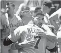  ?? GETTY IMAGES ?? Detroit’s Nicholas Castellano­s says goodbye to Jordy Mercer after being traded to the Chicago Cubs on Wednesday.