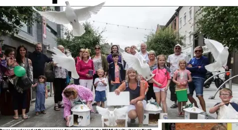  ??  ?? Doves are released at the awareness day event outside the WHAG charity shop on North Main Street; right: Ann Miller, Naomi Doherty and Leanne Kielty at the event.