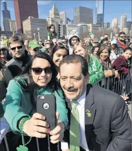  ?? Paul Beaty Associated Press ?? CHICAGO MAYORAL CANDIDATE Jesus “Chuy” Garcia poses for a selfie with Samantha Hernandez, 17, during the city’s St. Patrick’s Day parade.