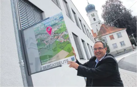  ?? FOTO: PHILIPP RICHTER ?? Bergatreut­es Bürgermeis­ter Helmfried Schäfer übt sich im Plakatiere­n. Die elektronis­ch angesteuer­te Halterung kommt aus Neukirch.