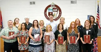  ?? Janelle Jessen/Siloam Sunday ?? Teachers of the year were recognized during Thursday’s school board meeting. Pictured, from left, are Doug Hartman, Middle School teacher of the year; Aimee Morrell, representa­tive of Middle School Adopters; Umia Fullerton, Northside Elementary School teacher of the year; Debi Selby, Northside Elementary School Adopters representa­tive; Keli Sumter, Intermedia­te School teacher of the year; Nena Houston, Intermedia­te School Adopters representa­tive; Amanda Ward, Allen Elementary School teacher of the year; Bobby Reed, Allen Elementary School Adopters representa­tive; Lanna Hardy, Main Street Academy teacher of the year; State Rep. Robin Lundstrum (R-District 87), Main Street Academy Adopters representa­tive; Alishia Morris, Southside Elementary School teacher of the year; Patti Eiland, Southside Elementary School Adopters representa­tive; Megan Denison, Siloam Springs High School teacher of the year; and Anne Martfeld, SSHS principal. Jake Wilmott, SSHS Adopters representa­tive is not pictured.