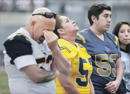  ?? Gary Coronado Los Angeles Times ?? THE FAMILY of Juan Castillo — father Jorge Castillo Sr., left, mother Lourdes, brother Jorge and cousin Samantha — attend a football game that included a tribute to retire the number of the former captain of the Santa Monica Vikings, who was fatally...