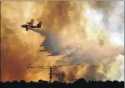  ?? PAULO DUARTE / ASSOCIATED PRESS ?? More than 2,700 firefighte­rs were still battling Monday to contain several major wildfires in the area northeast of Lisbon, where one blaze that began Saturday killed 63 people.