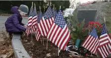  ?? PAUL CONNORS PHOTOS / BOSTON HERALD ?? TO HONOR HIM: Visitors pay tribute yesterday to the late President George H.W. Bush at a marker depicting his birthplace Milton, including local Republican official Tom Mountain, below, and Elizabeth Donahue, 6, above, of Milton.