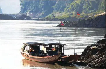  ??  ?? Boats dock on the bank of the Mekong River in northern Laos earlier last year at the planned constructi­on site for the Pak Beng Dam.