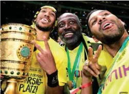  ?? AFPPIX ?? Dortmund forward Pierre-Emerick Aubameyang (left), his father Pierre Francois Aubameyang (centre) and brother Willy Aubameyang celebrate with the German Cup.