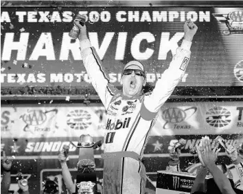  ?? JARED C. TILTON/GETTY IMAGES ?? Kevin Harvick celebrates in Victory Lane after winning the AAA Texas 500 Sunday at Texas Motor Speedway. The win, Harvick’s first at the Fort Worth track, sends the No. 4 Mobil 1 Ford driver into the Nov. 19 Monster Energy Cup title race.