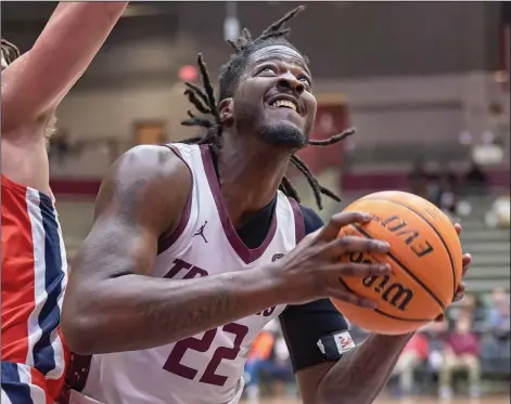  ?? (Photo courtesy of UALR Athletics) ?? Senior center Makhel Mitchell has emerged as a major factor for Arkansas-Little Rock during its five-game winning streak. In their past eight Ohio Valley Conference games, UALR has held its opponents to 61.1 points per game and the Trojans are 7-1 in that span.