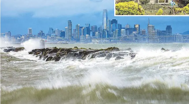  ?? AP ?? Waves crash over a breakwater in Alameda, California with the San Francisco skyline in the background on Sunday. High winds and heavy rainfall are impacting the region. Inset shows workers clearing a tree that fell onto a home during heavy wind and rain in San Jose, California.