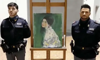  ??  ?? Italian police stand next to the masterpiec­e by Austrian artist Gustav Klimt. Photograph: Polizia Di Stato/Reuters