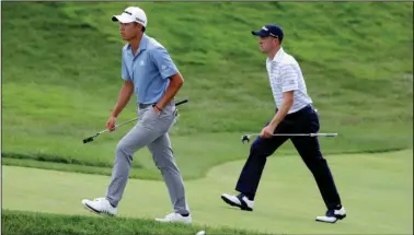  ?? The Associated Press ?? KEEPING IT CLOSE: Collin Morikawa, left, and Justin Thomas walk up the 18th green during the third round of the Workday Charity Open Saturday in Dublin, Ohio. Thomas leads the field with a 16-under 200 while Morikawa trails by just three strokes.