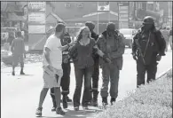  ?? AP ?? A woman is led to safety Saturday after the attack in Ouagadougo­u, Burkina Faso, in this image from television. People from 18 countries were among the victims.