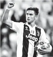  ?? AP ?? HAT TRICK. Juventus forward Paulo Dybala holds the ball after scoring a hat trick at the end of the Champions League, group H soccer match between Juventus and Young Boys, at the Allianz stadium in Turin, Italy, Tuesday, Oct. 2, 2018.