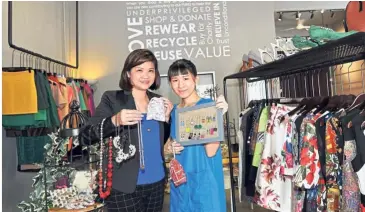  ??  ?? Shop for a good cause: Pang (left) and her colleague Jeslynn Chong, 24, showing some of the items available at the Momo Love Concept shop.