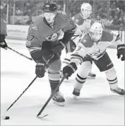  ?? Chris Carlson Associated Press ?? RICKARD RAKELL of the Ducks gets inside track on the puck against Dan Hamhuis of the Dallas Stars.