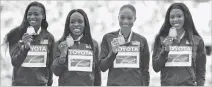  ?? MARTIN MEISSNER/THE ASSOCIATED PRESS ?? The U.S. Women’s 4x100 meters relay team, from left, Teri Bowie, Aalyah Brown, Allyson Felix and Morolake Akinsosun pose on the podium Sunday with their gold medals at the World Athletics Championsh­ips in London.