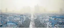  ??  ?? CITY OF SMOG: The Paris skyline is unrecognis­able under a blanket of fog