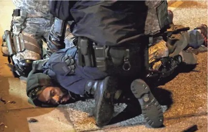  ?? JEFF ROBERSON/AP ?? Police restrained MacNore Cameron at a 2014 protest in Ferguson, Mo., using the same hold that killed George Floyd. He says Floyd’s death brought back emotions. “That could have easily, easily been me. Dead in the street.”