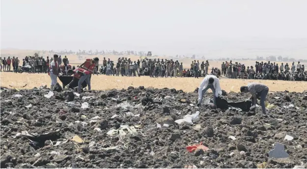  ?? PICTURE: GETTY IMAGES ?? 0 Rescue teams sift through the wreckage for remains of passengers who were killed when Ethiopian Airlines flight ET302 crashed.