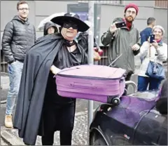  ?? MARCO BERTORELLO/AFP ?? A man dressed as Zorro is seen in downtown Milan.