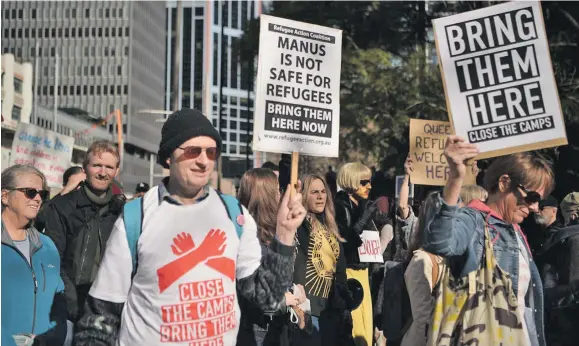  ?? Photo: AFP ?? Demonstrat­ors march during a protest to demand humane treatment of asylum seekers and refugees in Sydney, Australia, on July 21, 2018.