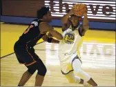  ?? NHAT V. MEYER — BAY AREA NEWS GROUP ?? Warriors rookie James Wiseman, right, controls the ball against the Raptors’ OG Anunoby on Sunday.