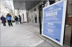  ?? AP photo ?? People who had appointmen­ts to get COVID-19 vaccinatio­ns talk to New York City health care workers Thursday outside a closed vaccine hub in the Brooklyn borough of New York after they were told to come back in a week due to a shortage of vaccines.