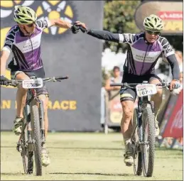  ??  ?? Heinz Zoerweg and Barti Bucher of team Meerendal CBC 3 win the Grandmaste­r category of stage 6 of the 2017 Absa Cape Epic Mountain Bike stage race from Oak Valley Wine Estate in Elgin yesterday.