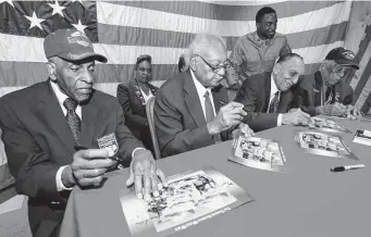  ?? Marvin Pfeiffer / Staff photograph­er ?? Tuskegee Airmen Dr. Granville Coggs, from left, James Bynum, Dr. Eugene Derricotte and Thomas Ellis sign autographs at Joint Base San Antonio-Lackland in 2015. Each one is a hero.