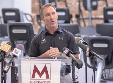  ??  ?? Tom Hatten, founder and CEO of Mountainsi­de Fitness, speaks during a press conference Tuesday as his operation’s headquarte­rs in Scottsdale.