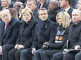 ?? (TÉLAM) ?? Trump, Merkel, Macron, su esposa, y Putin.