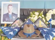  ??  ?? A tableau of flags, flowers and a photograph of State Police Sgt. Brian Mohl rests at the edge of the stage Thursday at Xfinity Theatre.