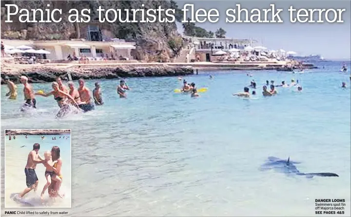  ??  ?? DANGER LOOMS Swimmers spot fin off Majorca beach