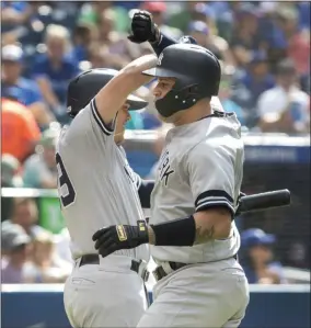  ?? FRED THORNHILL - THE ASSOCIATED PRESS ?? New York Yankees’ Gary Sanchez celebrates with teammate Gio Urshela after hitting a home run during the fourth inning of a baseball game against the Toronto Blue Jays, Saturday, Aug. 10, 2019 in Toronto.