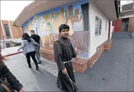  ?? Al Seib
Los Angeles Times ?? FATHER LUIS GUZMAN outside Assumption Catholic Church in Boyle Heights, where an 80- year- old man was robbed of $ 4,100 in church collection­s.