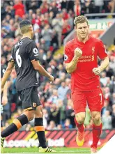  ??  ?? James Milner celebrates scoring Liverpool’s fifth from the spot.