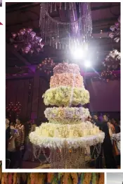  ??  ?? The guests whipped out their phones to take photos of the cake, and some couldn’t resist breaking off the edible flowers for a taste