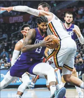  ?? Robert Gauthier Los Angeles Times ?? CLIPPERS guard Paul George drives on New Orleans Pelicans center Jonas Valanciuna­s, who scored 39 points and 15 rebounds, during first-half action.