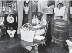  ??  ?? Omar Daley working in his section of the Artisan Village Falmouth booth at the recent Caribbean Travel Marketplac­e, held at the Montego Bay Conference Centre in St James.