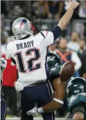 ?? MATT YORK -AP ?? The Philadelph­ia Eagles’ Brandon Graham, center, strips the ball from Patriots quarterbac­k Tom Brady during the second half of Super Bowl 52 Sunday.