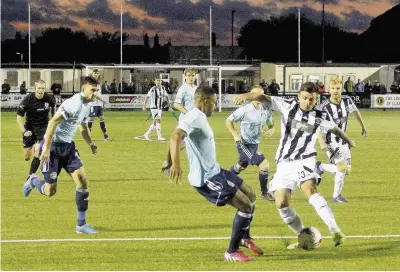  ?? Pic: Steve Lewis ?? Llandudno’s match-winner Lewis Buckley (stripes) takes on Rhyl’s Ibou Touray