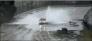  ?? MATT BORN/THE STAR-NEWS VIA AP ?? A car drives through water caused by the rain from Florence, now a tropical storm on U.S. 74⁄76 in Leland, N.C., Saturday, Sept.15, 2018. The rain from Hurricane Florence was expected to continue through Sunday.